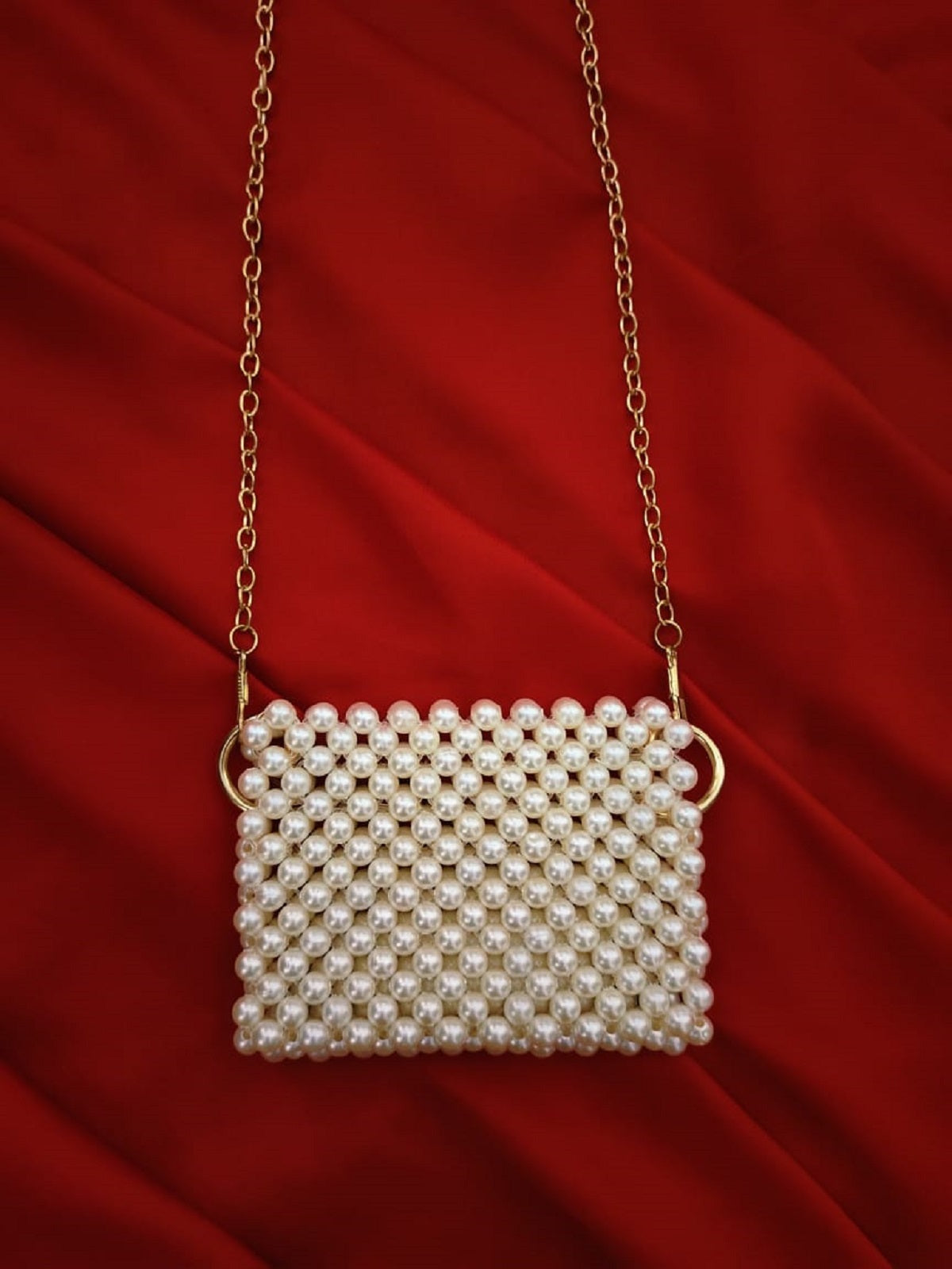 Close-up of a handcrafted mini off-white beaded pouch with intricate beadwork patterns