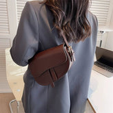 Branded Brown Leather Shoulder Bag carrying a girl