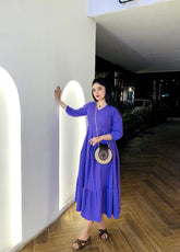 Model carrying the Skin and Black Wooden Cross Body Bag with Long Golden Strap over the shoulder