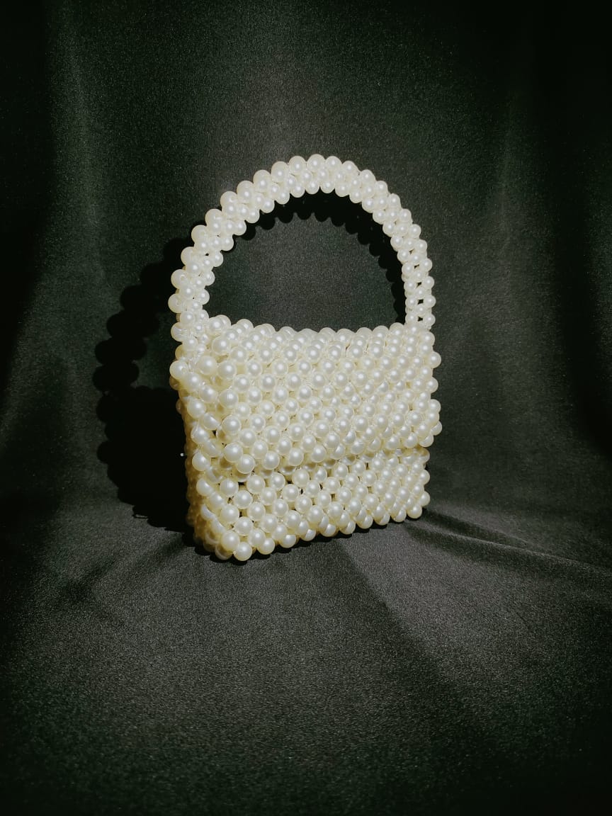 "OffWhite Mini Beaded Handbag, a sophisticated white beaded bag, designed as a handmade purse with customized features. This beaded shoulder bag stands out in the collection of hand made bags, offering elegance in the form of a beaded crossbody bag