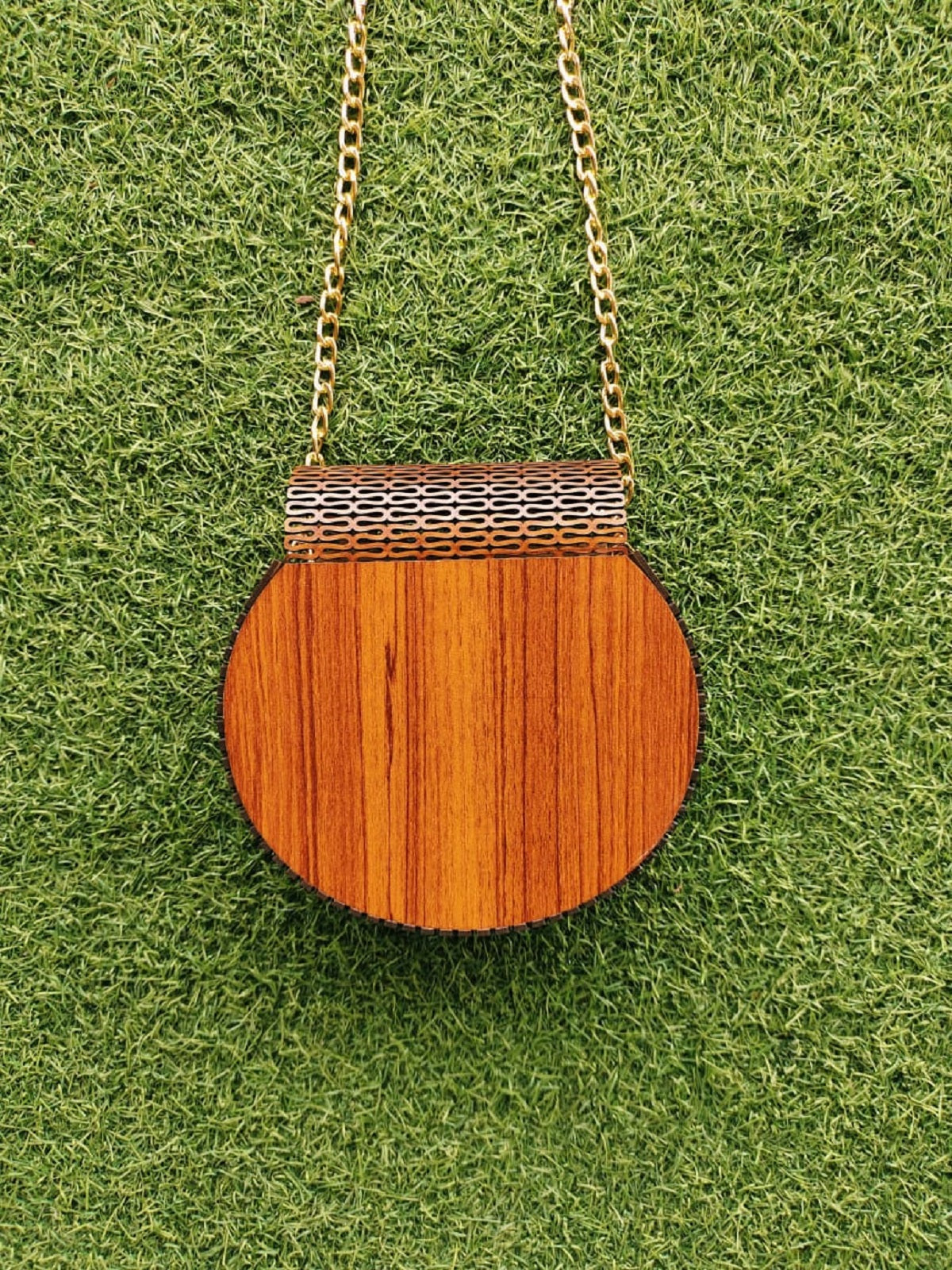 Handcrafted wooden handbag with a distinctive curve, embodying both natural grace and artisanal expertise