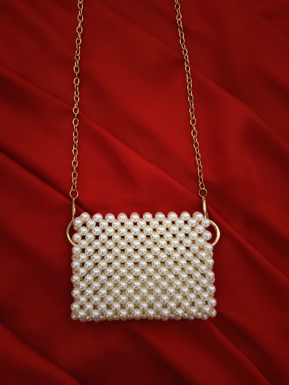 Close-up of a handcrafted mini off-white beaded pouch with intricate beadwork patterns