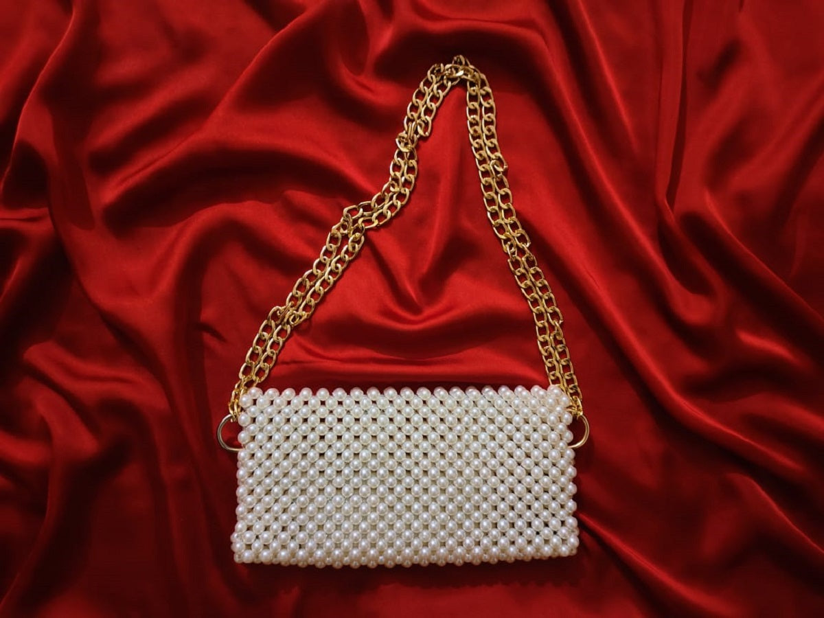 Detailed close-up showcasing the meticulous beadwork on the off-white shoulder bag, with a mix of pearl-like and shimmering beads