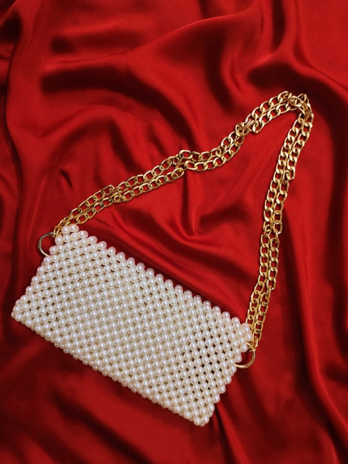 Off-white beaded shoulder bag embellished with intricate patterns, complemented by a shimmering golden strap